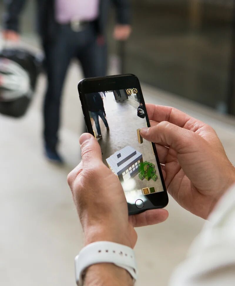 Person building with the SpotBuild app on a phone